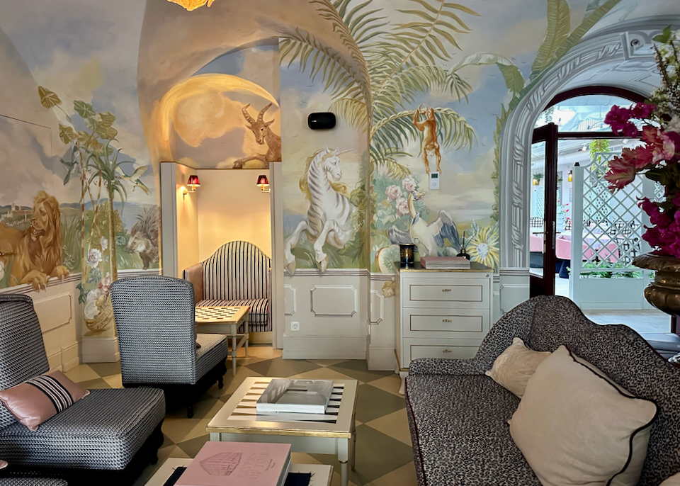 Bright and cozy hotel lobby with woodland murals painted on the walls