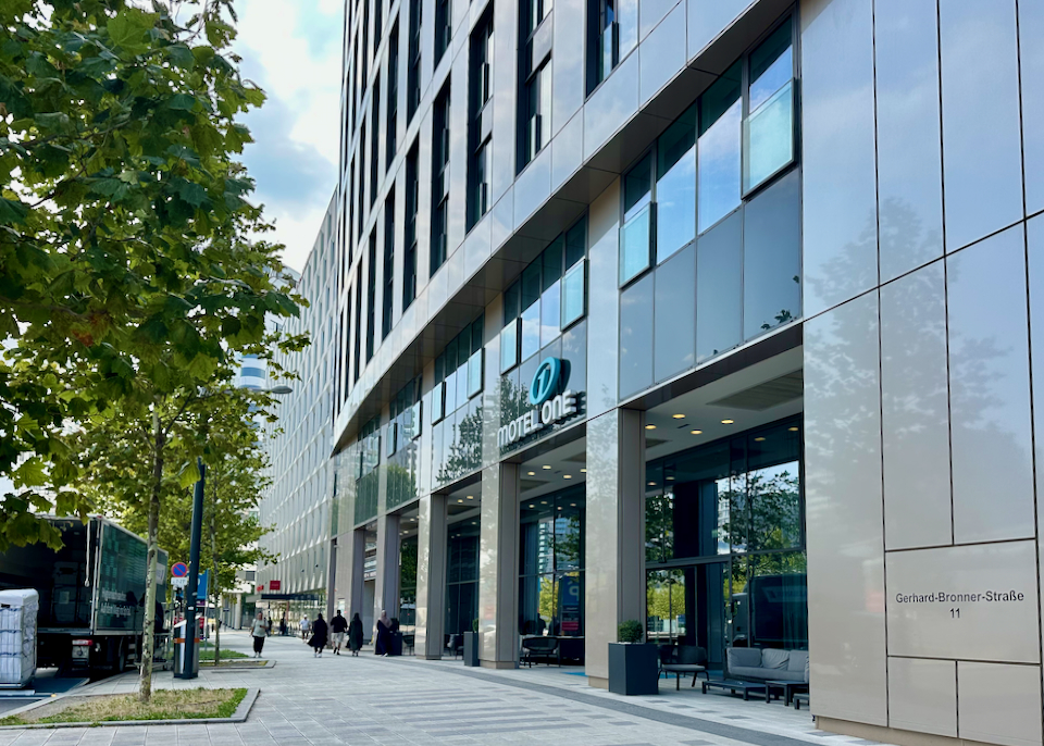 Exterior of a modern hotel with tall plate glass windows.