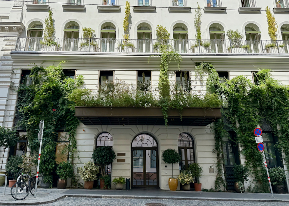 Hotel exterior, draped with hanging plants
