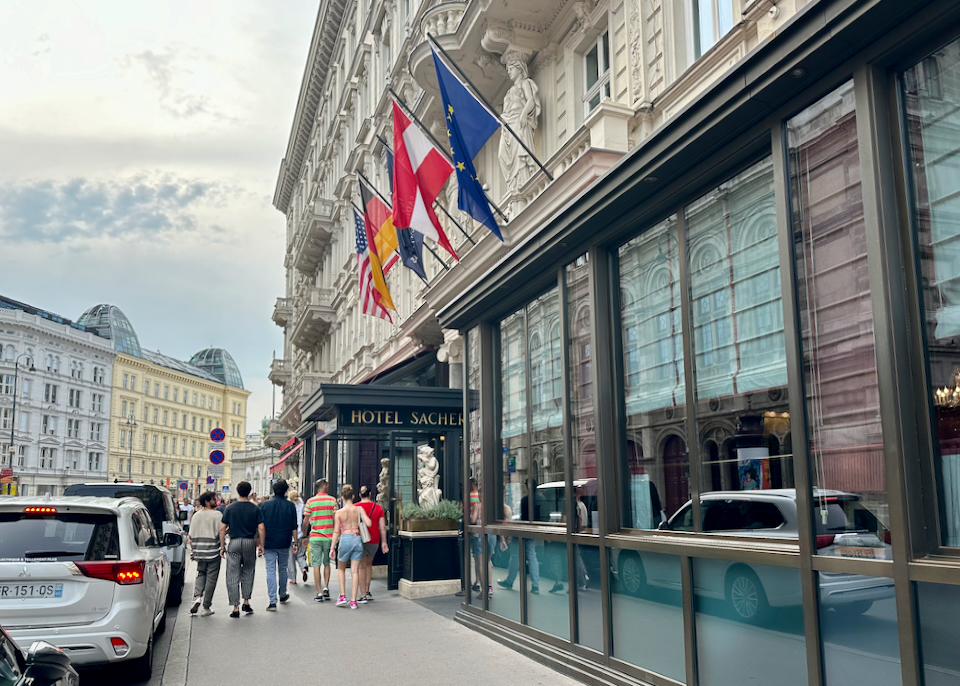 People walk past the entrance to a luxury hotel