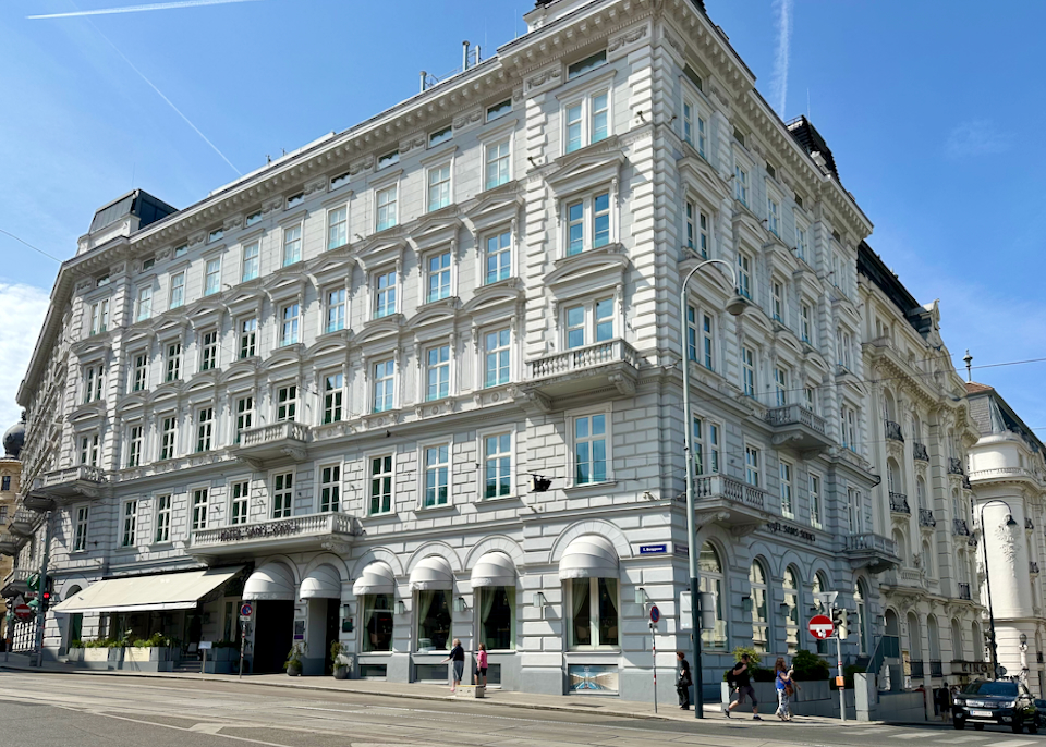 Corner view of a large historic hotel on a Viennese street