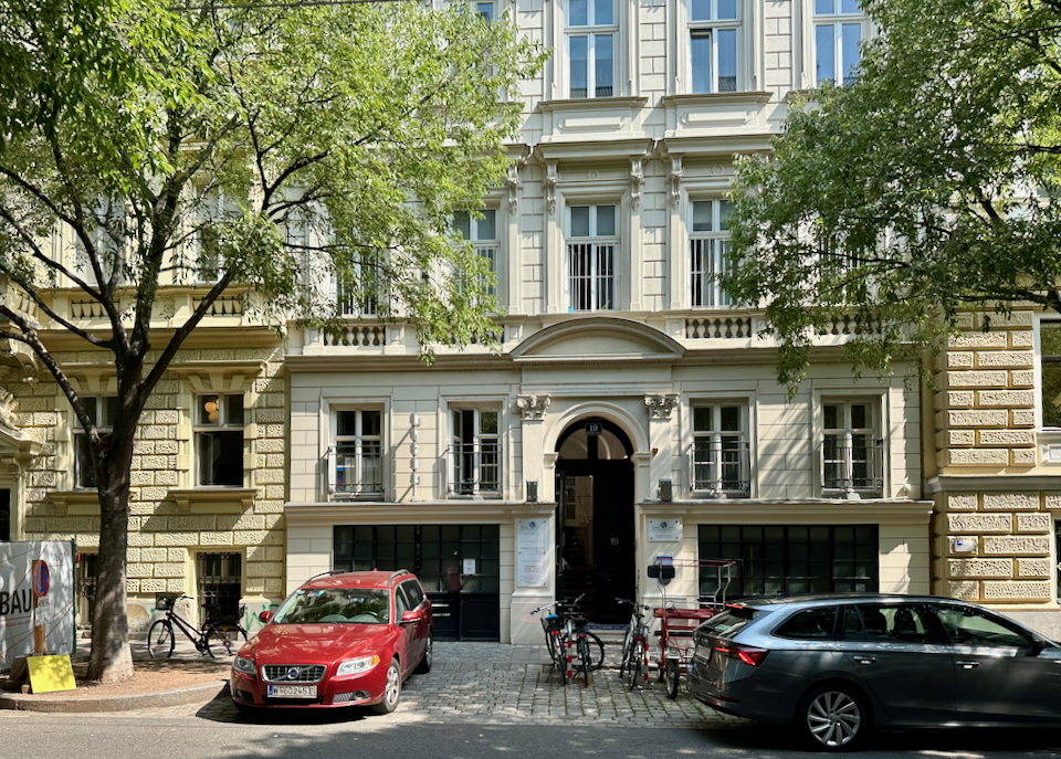 Exterior of a small boutique hotel on a leafy Viennese street