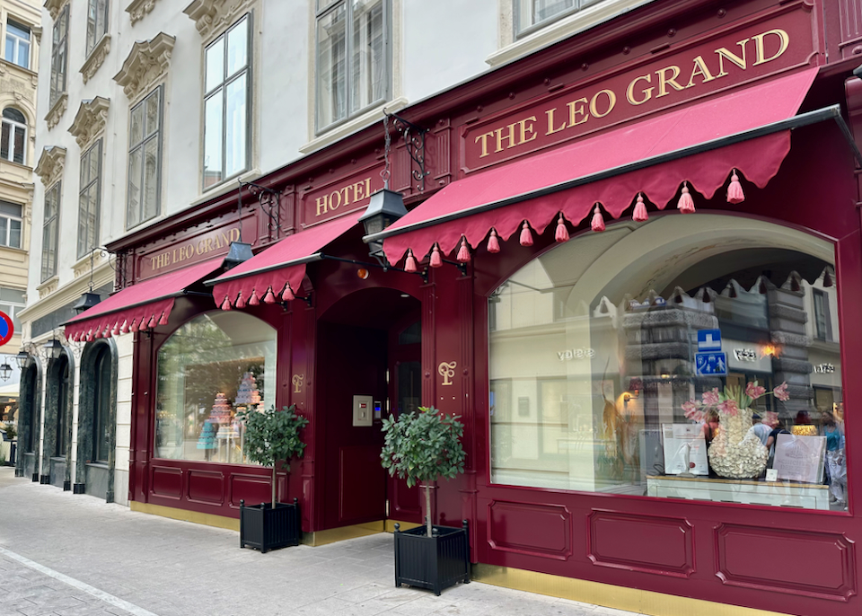 Red exterior and awning of a boutique hotel in Vienna