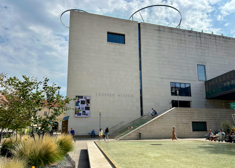 Green lawn in front of a modern leading up to the Leopold Museum in Vienna. 