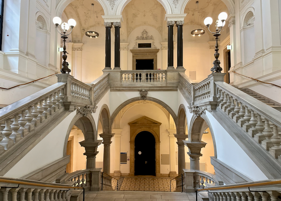 Elegant interior of a Vienna university building, with grand stone staircases