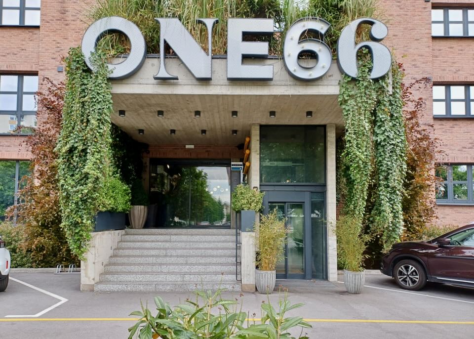 A large outdoor sign reads, "One66."