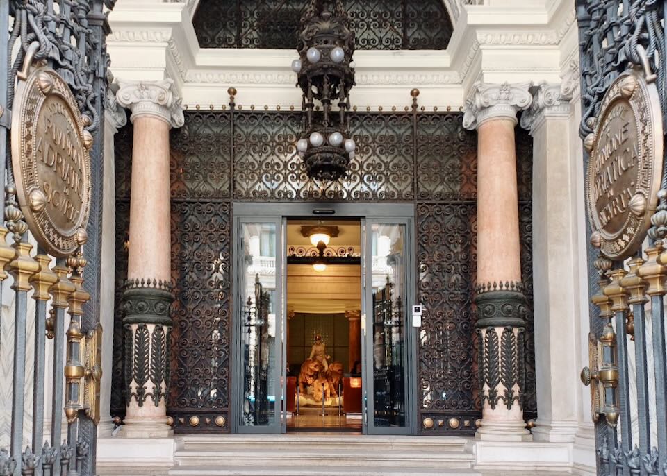 Ornate wrought iron embellishes windows.