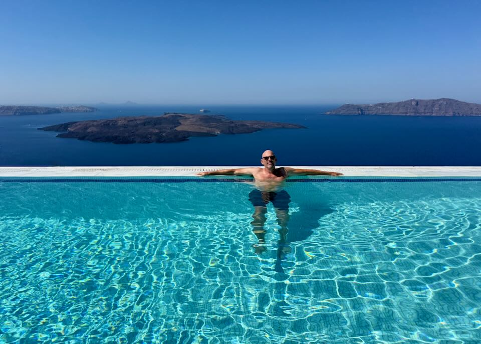 Me in Santorini pool with caldera view.