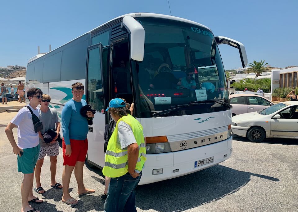 My sons getting on the bus in Ornos.