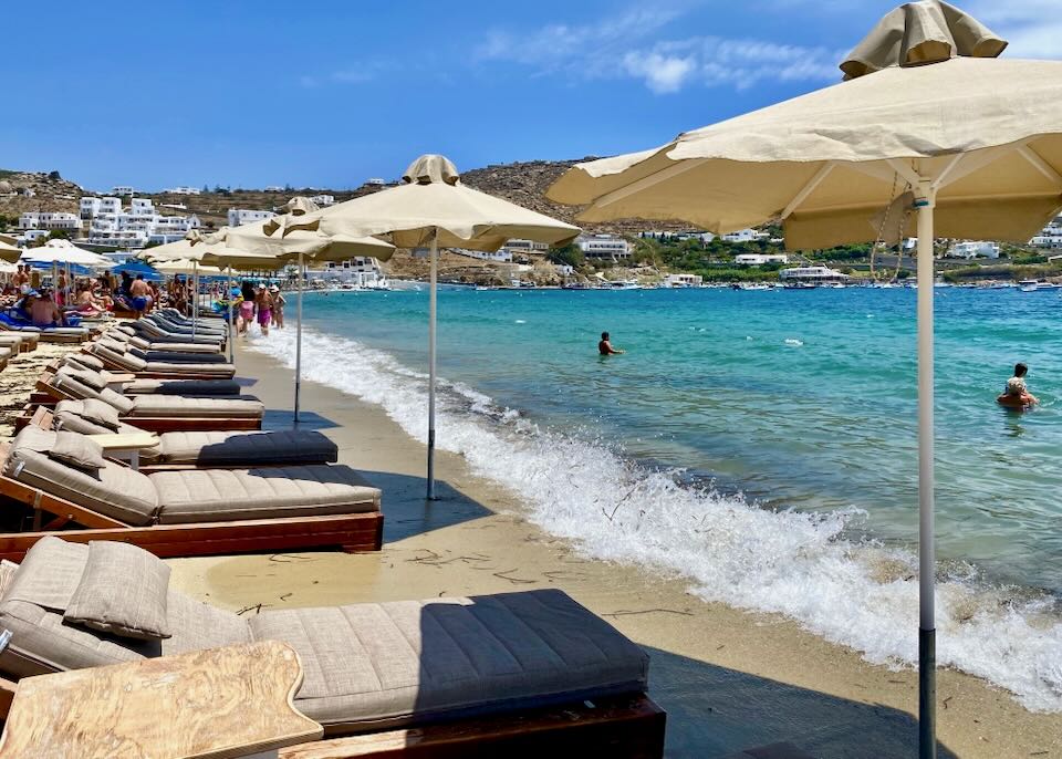 Sun beds for rent at Ornos Beach.