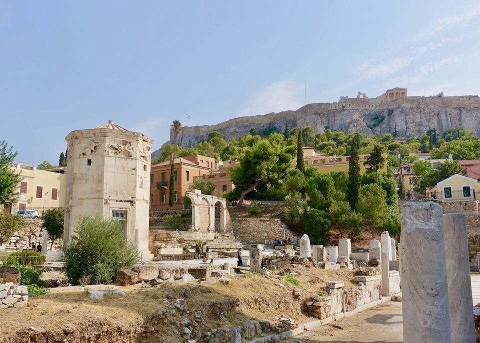 View of the ruins of the Roman Agora with the Acropolis behind it.