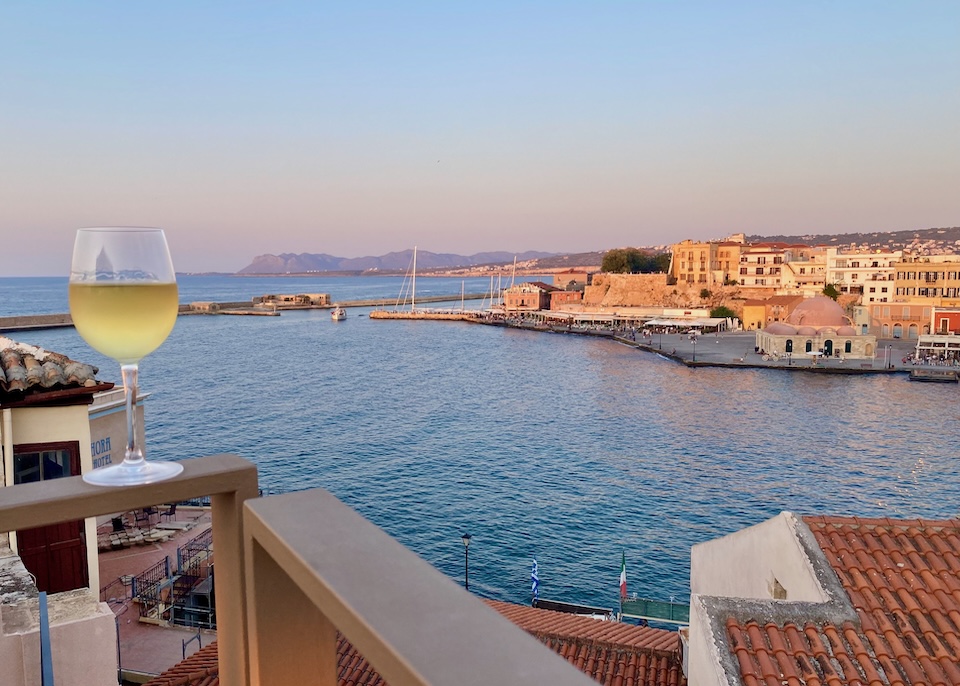 View of Chania's Venetian Harbor and Kiutsuk Hasan Mosque near sunset.