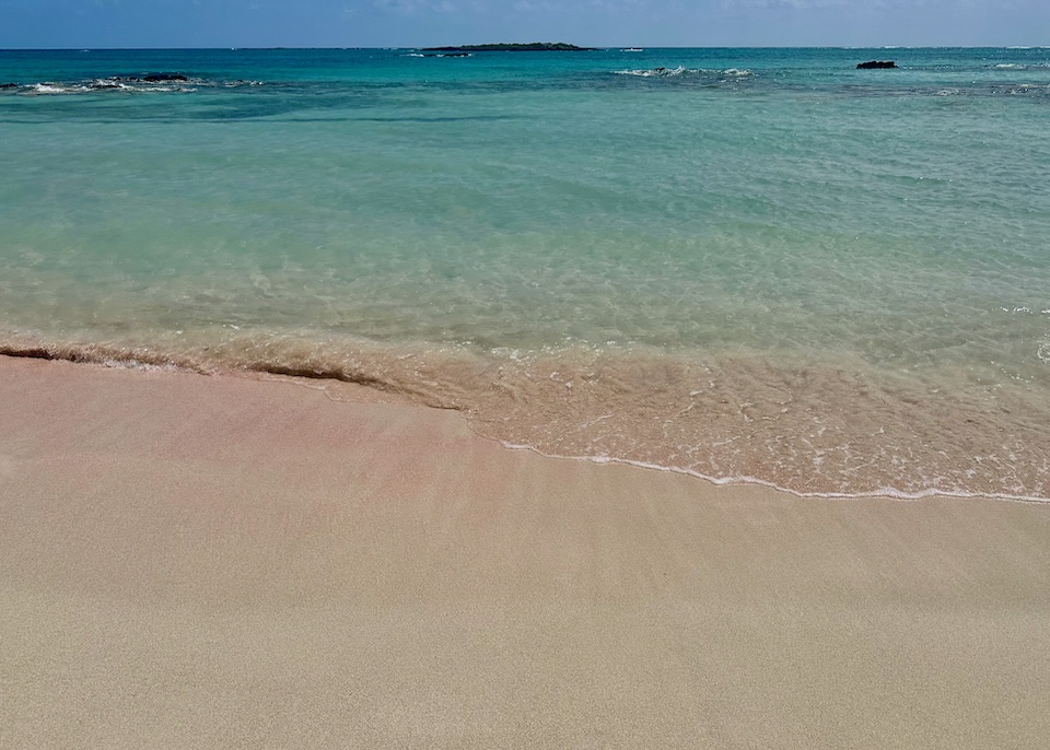 Slightly pink sand and a waveless sea in Elafonisi, Crete.