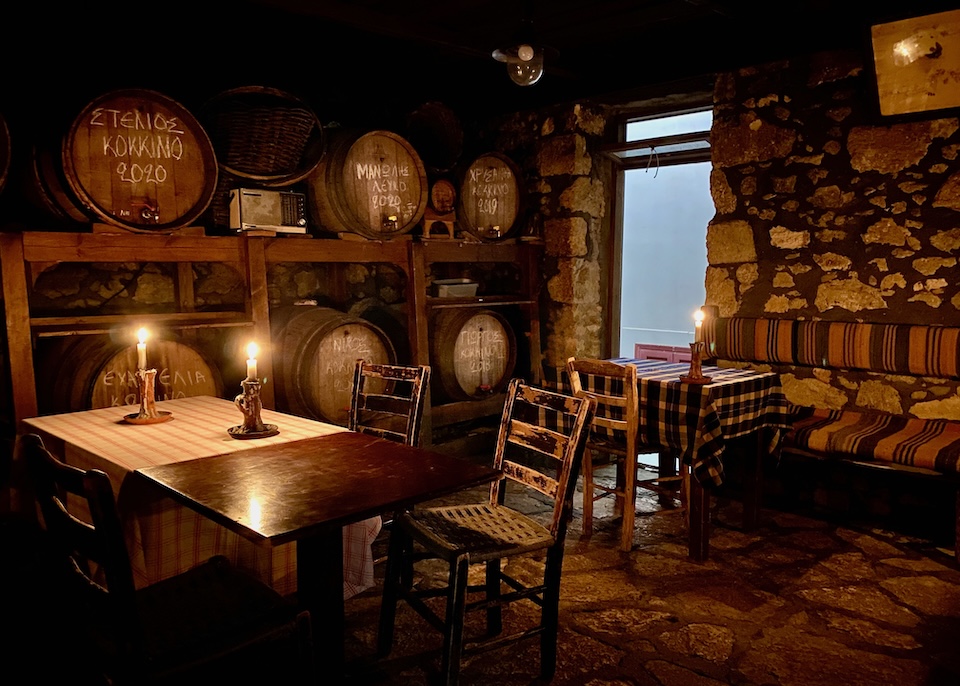 A dining room with wine barrels lit by candles at Giannis Tavern near Heraklio..