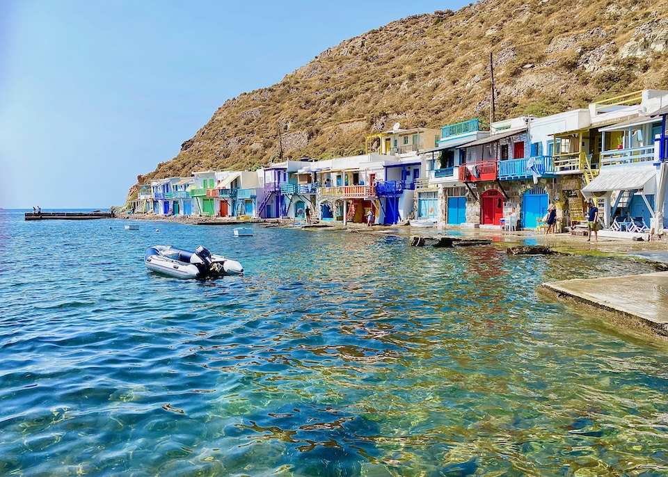 Colorful boathouses line the shore in Klima, Milos.