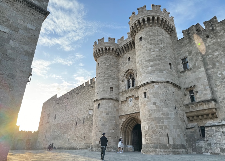 An imposing Gothic-style castle just before sunset
