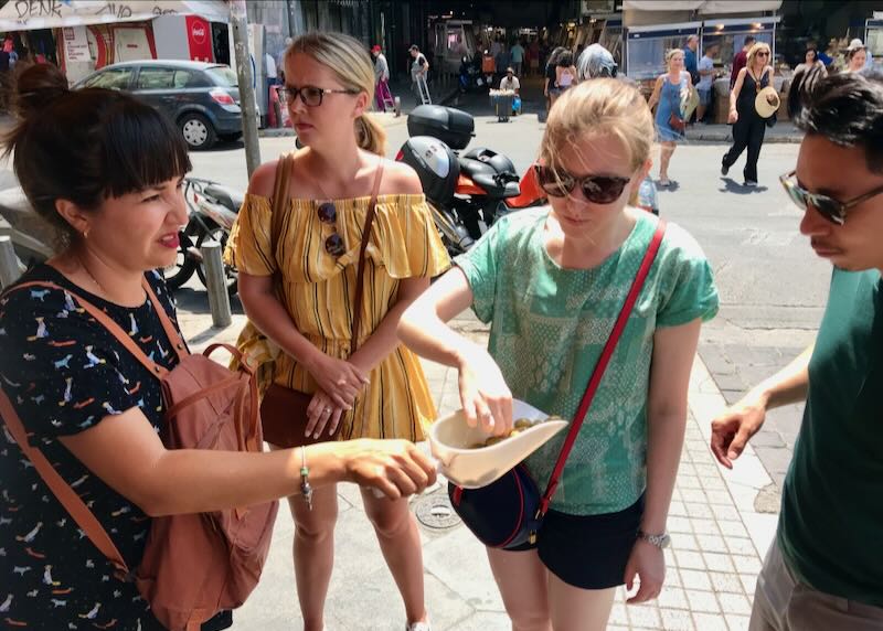 Sampling olives during my food tour of Athens.