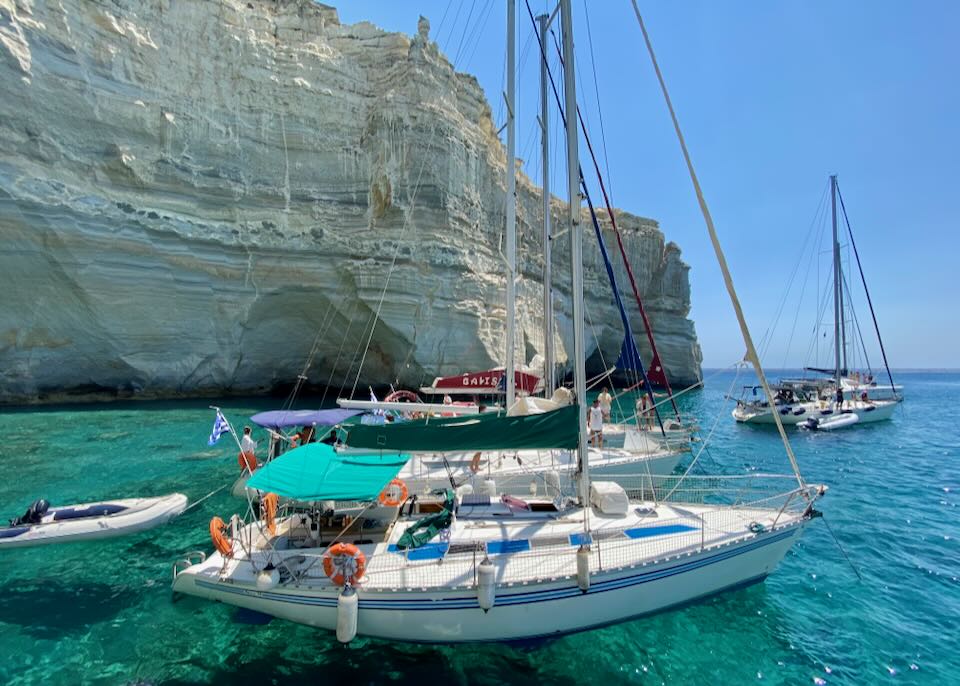 Boat charters floating near Kleftiko Cave in Milos.