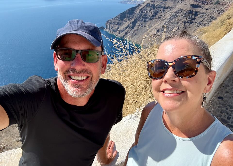 My wife and I enjoying a peaceful and safe afternoon overlooking the Santorini caldera in Greece.