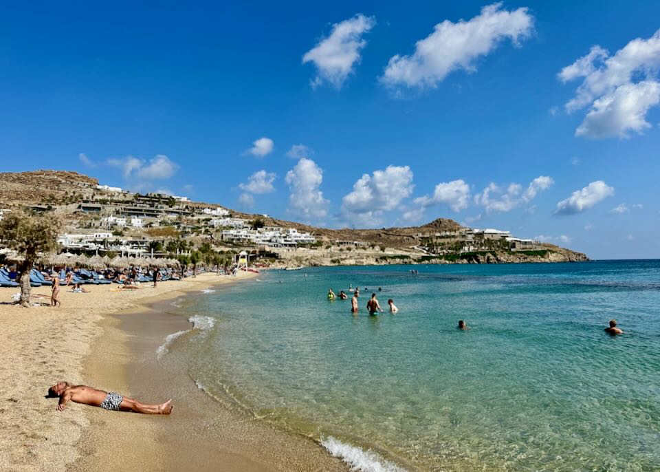 Swimming and sunbathing at a Mykonos beach in September.
